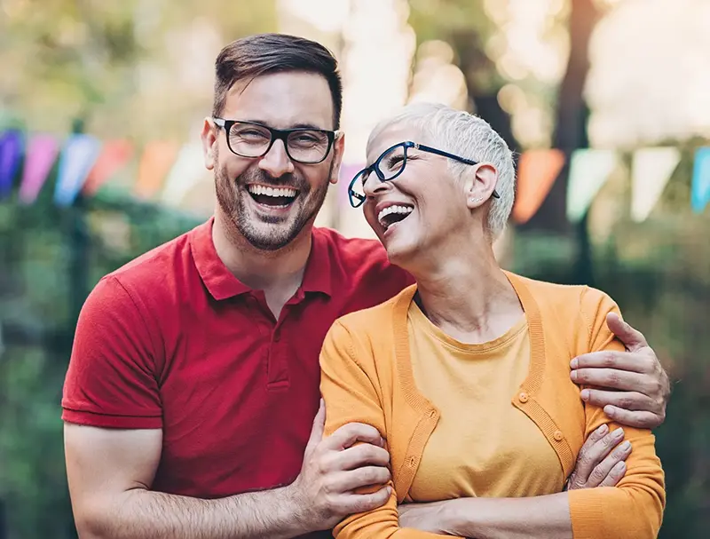 Woman and adult man smiling