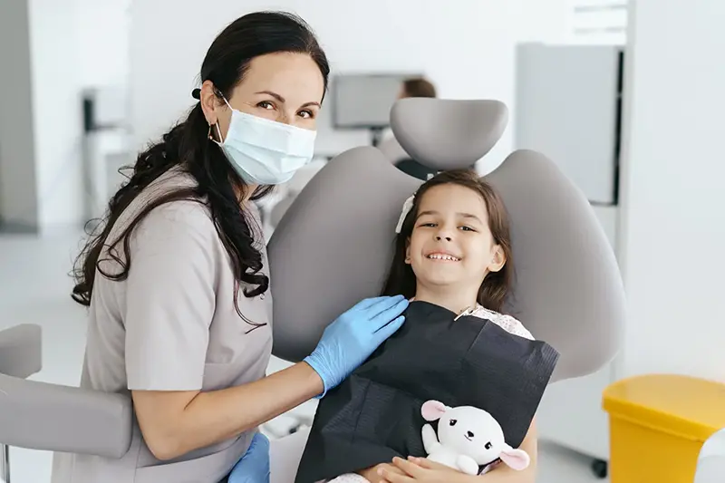 Little girl smiling with dentist
